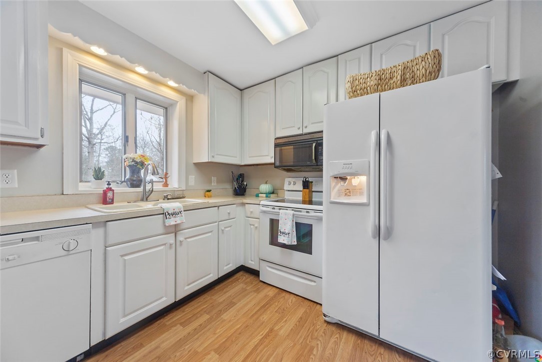 4210 Treely Road Chester, VA 23831 - Photo 7 of 39 a kitchen with white cabinets and white appliances