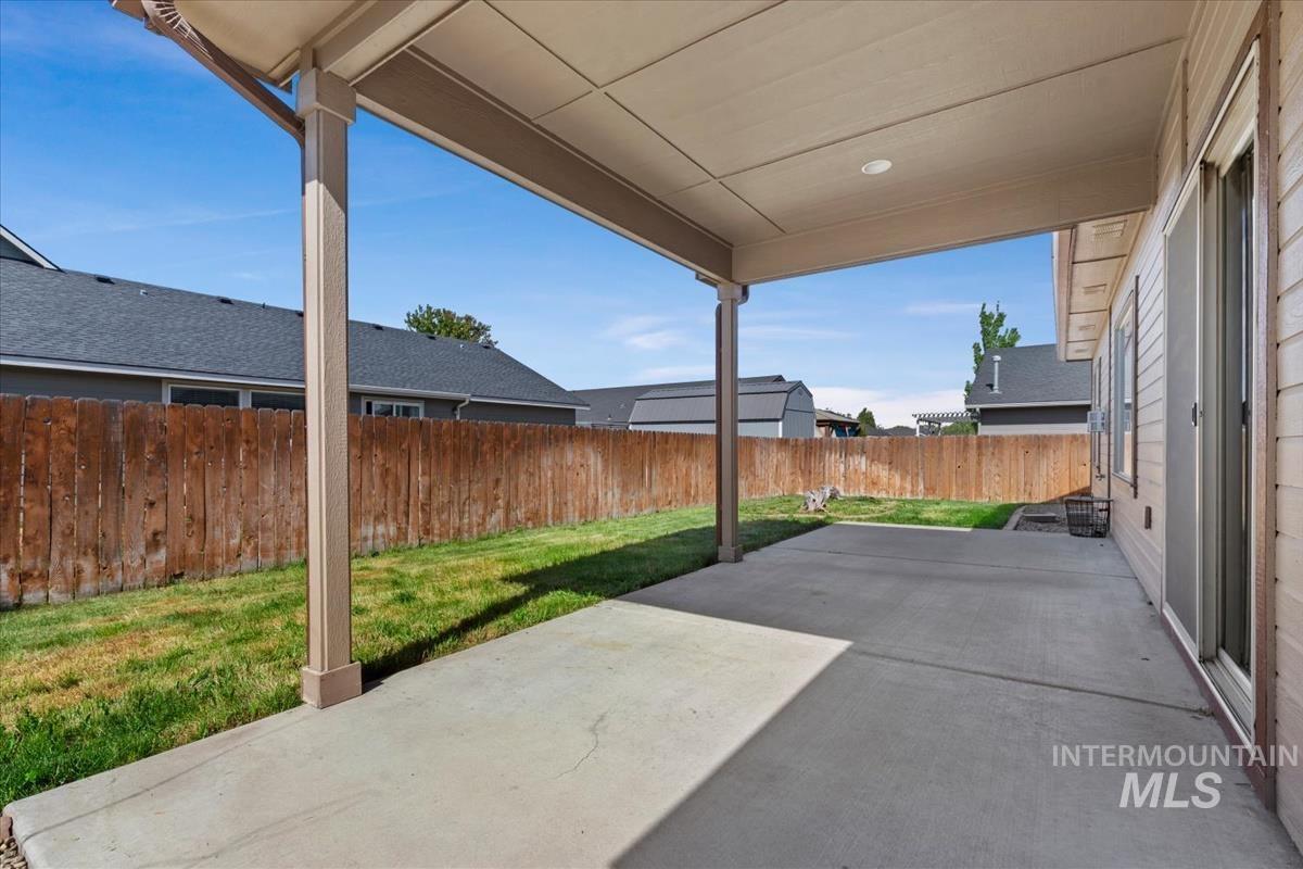 640 Southwest Miner Street Mountain Home, ID 83647 - Photo 8 of 35 Covered concrete patio with recessed lighting, offering direct access to a private yard with a wood privacy fence