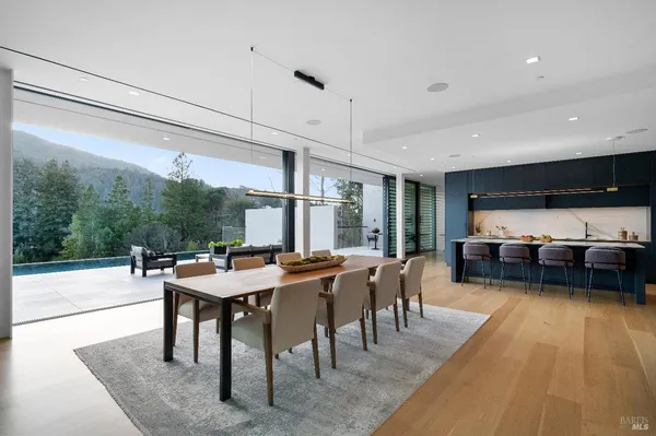 a dining room with furniture and wooden floor