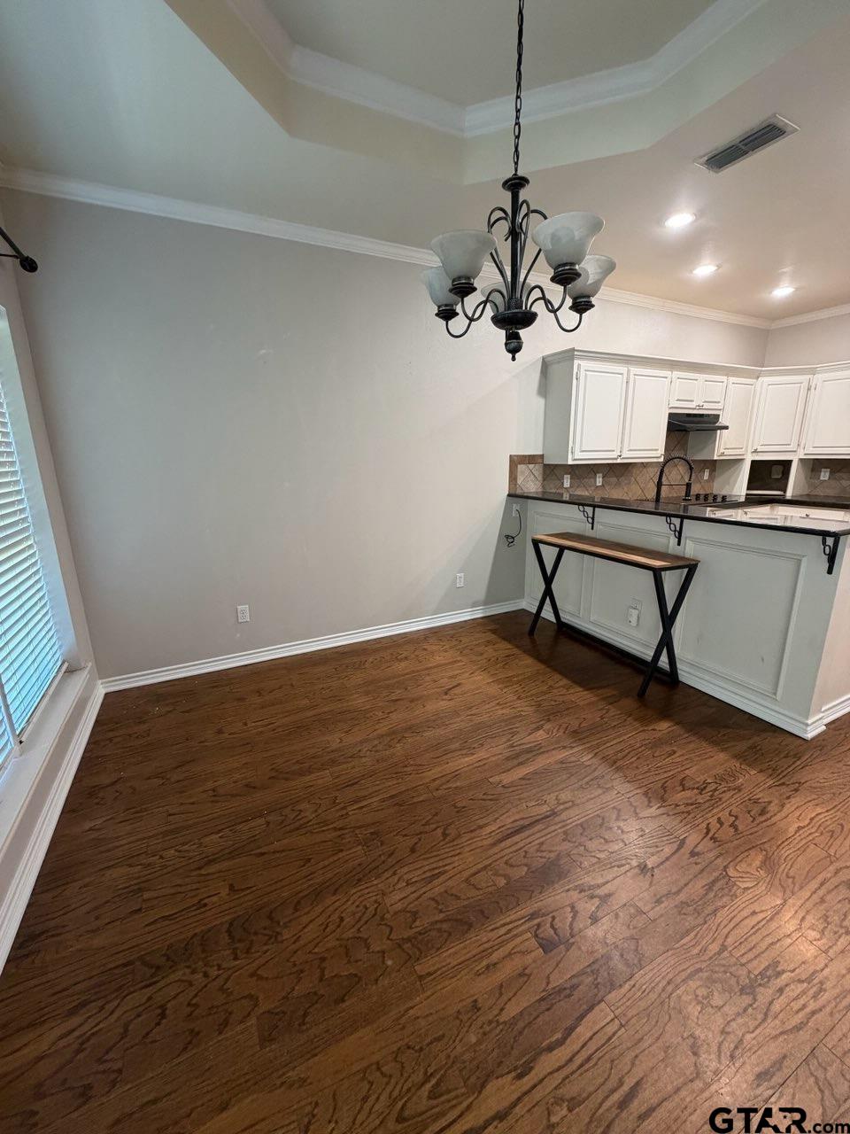 3204 Pebblebrook Circle Tyler, TX 75707 - Photo 4 of 18 a view of a room with wooden floor and furniture