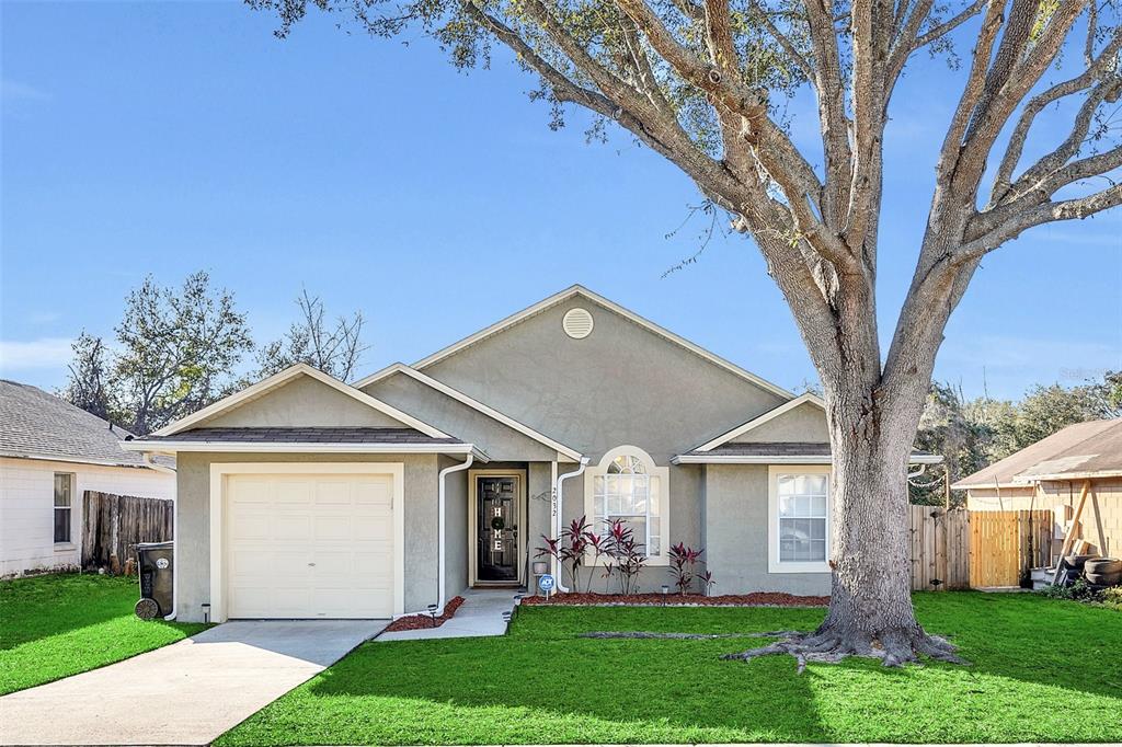 2032 Lauren Road Apopka, FL 32703 - Photo 1 of 1 a front view of a house with a yard and a large tree