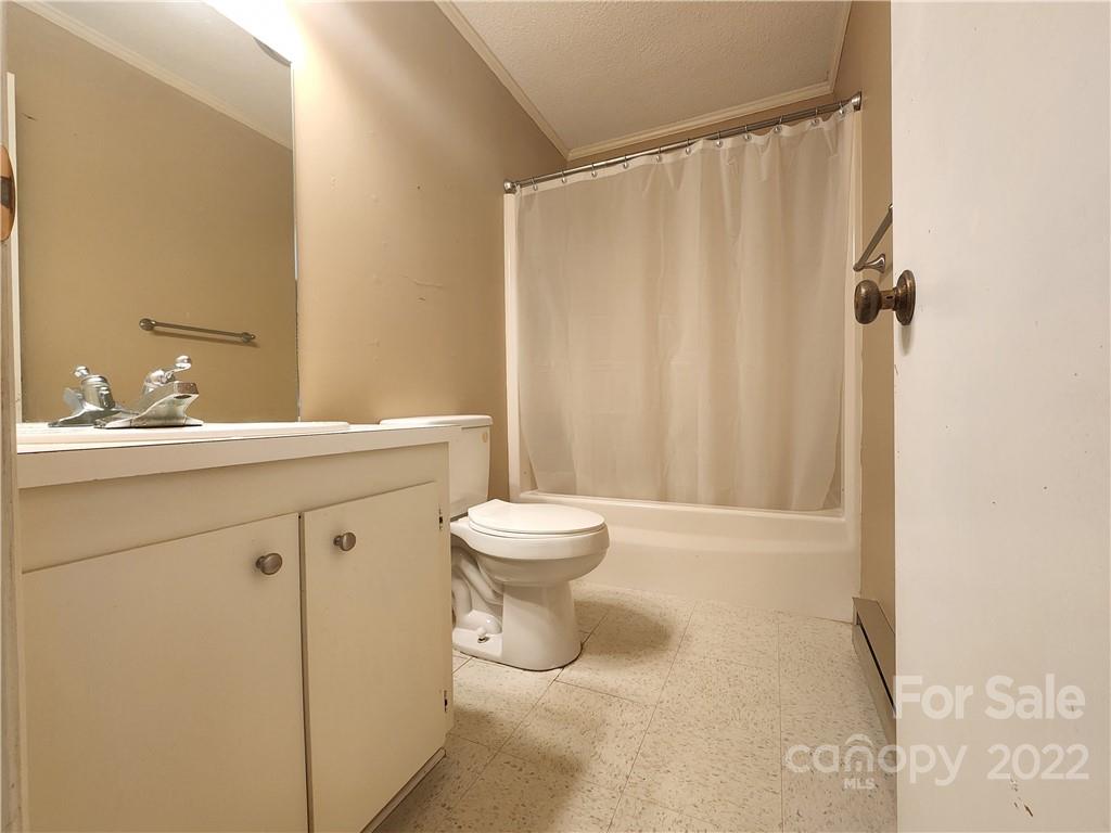291 Cherokee Way Marion, NC 28752 - Photo 11 of 14 a bathroom with a sink a toilet and shower