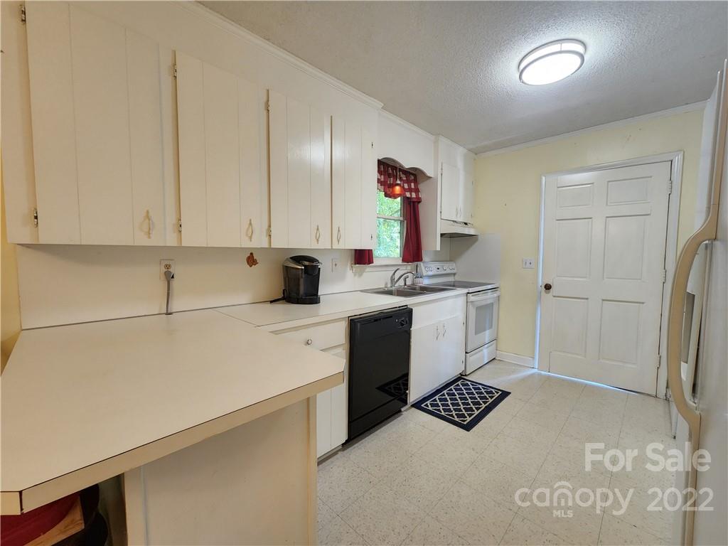 291 Cherokee Way Marion, NC 28752 - Photo 7 of 14 a kitchen with a refrigerator sink and cabinets
