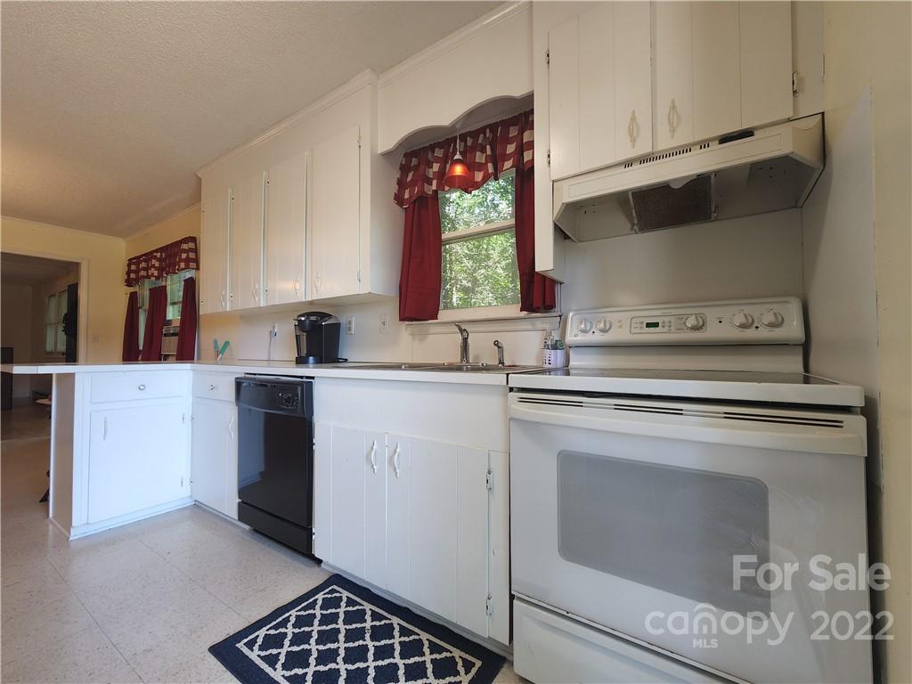 291 Cherokee Way Marion, NC 28752 - Photo 9 of 14 a kitchen with a stove cabinets and window