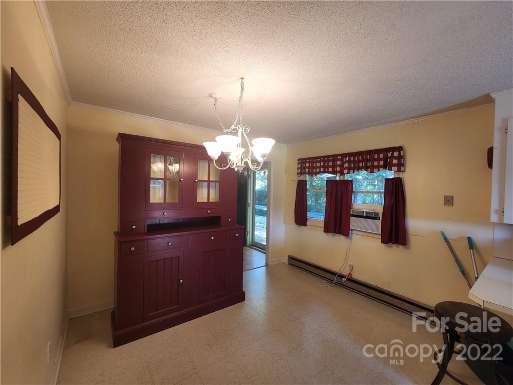 291 Cherokee Way Marion, NC 28752 - Photo 10 of 14 a spacious en suite bathroom with a granite countertop sink a light fixture and a fireplace