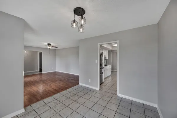 a view of an empty room and a bathroom