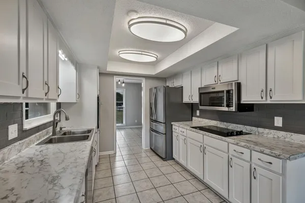 a kitchen with stainless steel appliances granite countertop a sink and cabinets