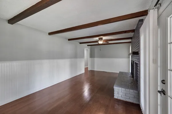 a living room with wooden floors and a fireplace
