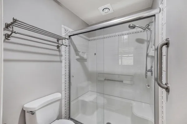 a view of a livingroom with a ceiling fan and window