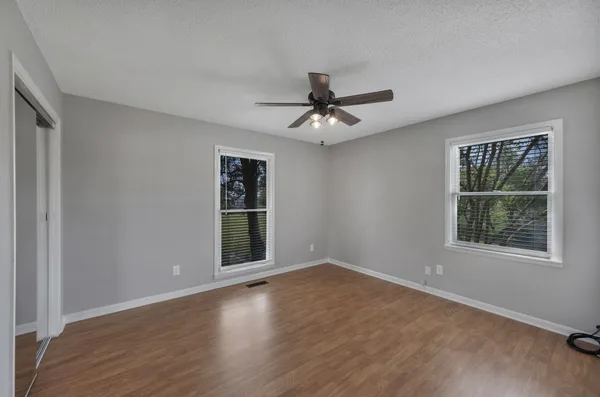 a view of a livingroom with furniture ceiling fan and window