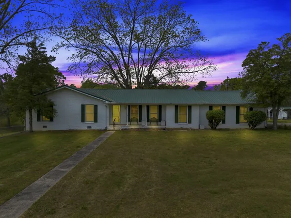 a front view of a house with a garden