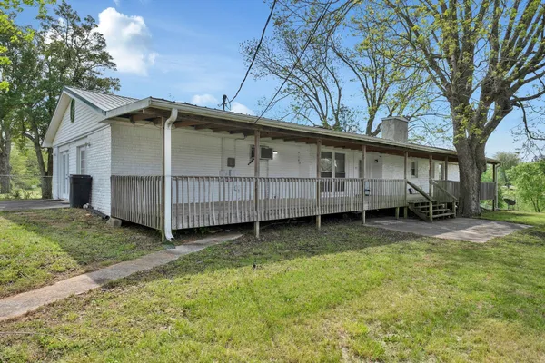 a view of porch with green trees in front