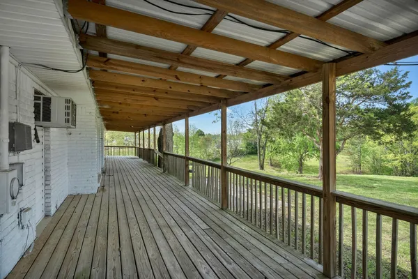a view of a big room with wooden floor and windows
