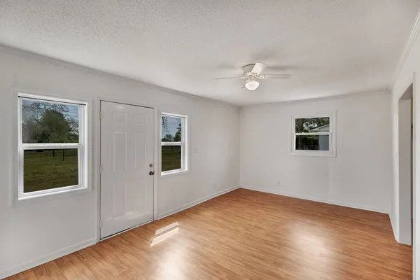 a kitchen with granite countertop a stove top oven and cabinets