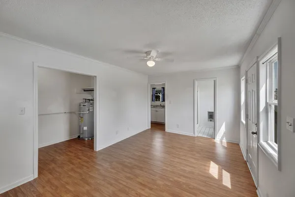 a view of a room with wooden floor kitchen chandelier and entryway