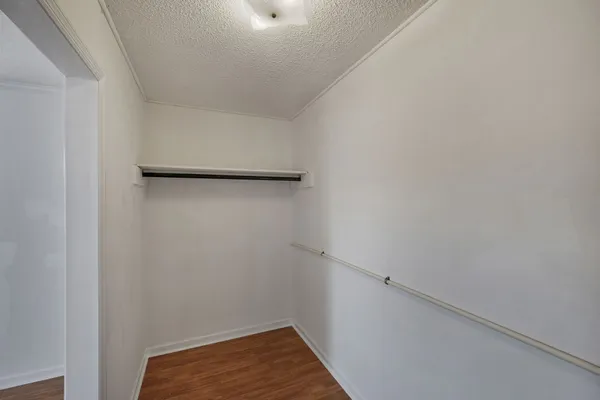 a kitchen with granite countertop a sink a stove and cabinets