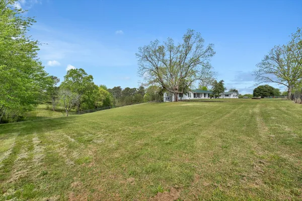 a view of a swimming pool and lounge chairs