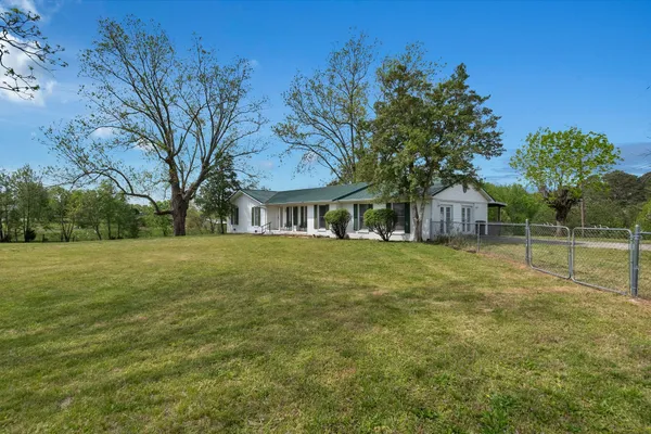a front view of house with yard and green space