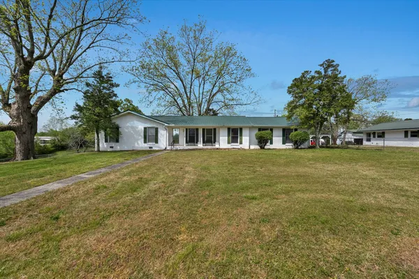 a front view of house with yard and green space