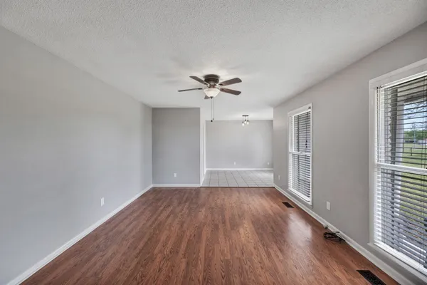 wooden floor in an empty room with a window
