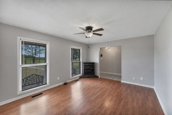 wooden floor in an empty room with a window