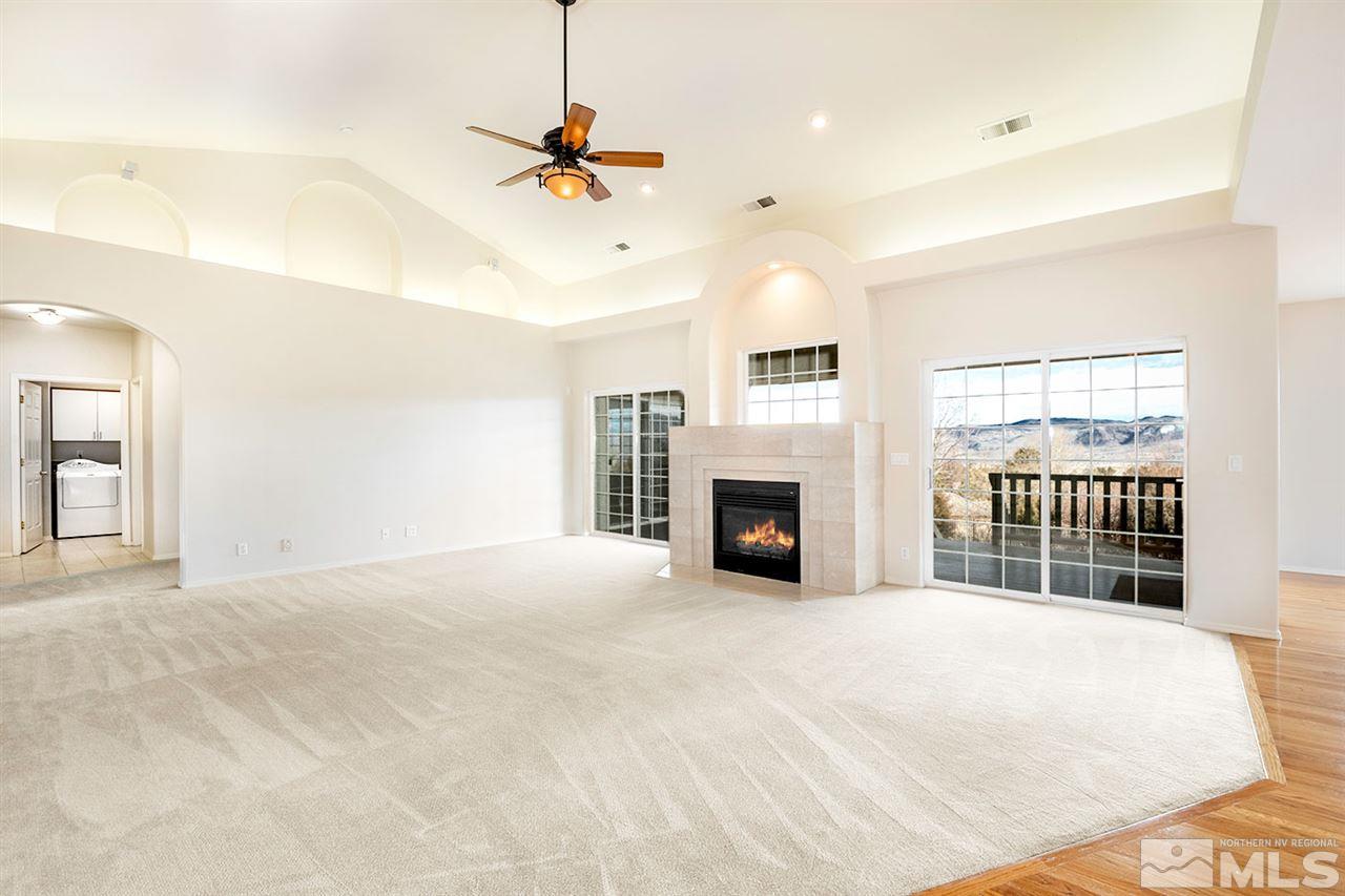 140 Gazelle Road Reno, NV 89511 - Photo 8 of 26 a view of an empty room with a fireplace and a window