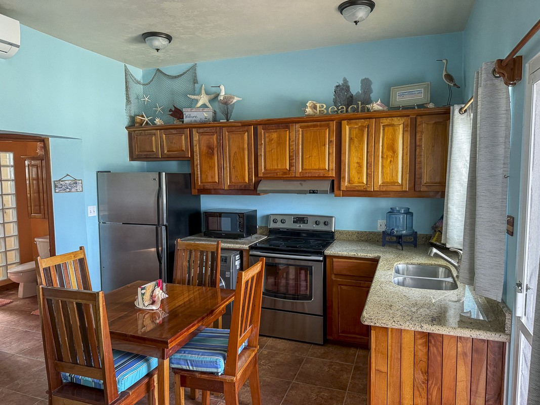 0 Sapphire Beach, Unit 17C2 Robstown, TX 78380 - Photo 6 of 12 a kitchen that has a cabinets counter space stainless steel appliances and a window