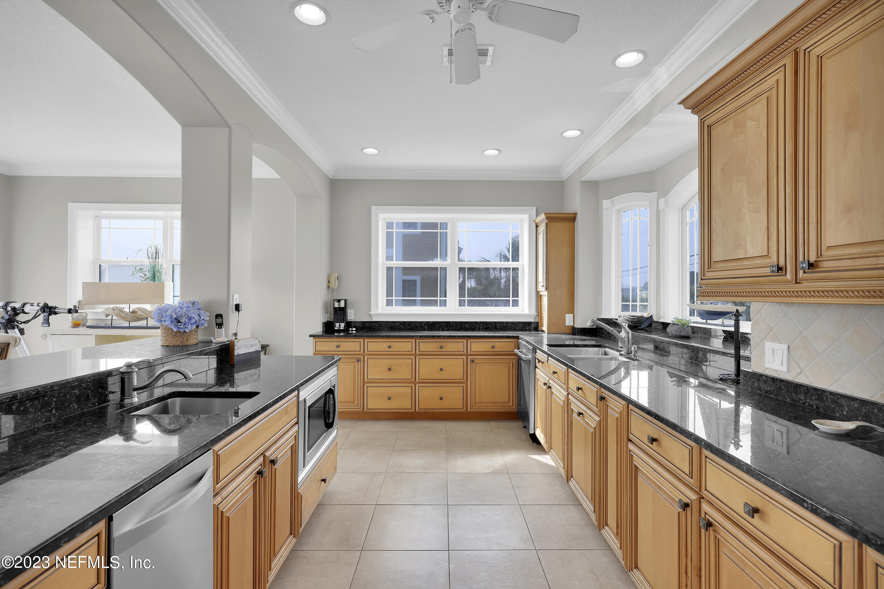 4582 Coastal Highway St. Augustine, FL 32084 - Photo 17 of 45 a large kitchen with granite countertop a sink and cabinets
