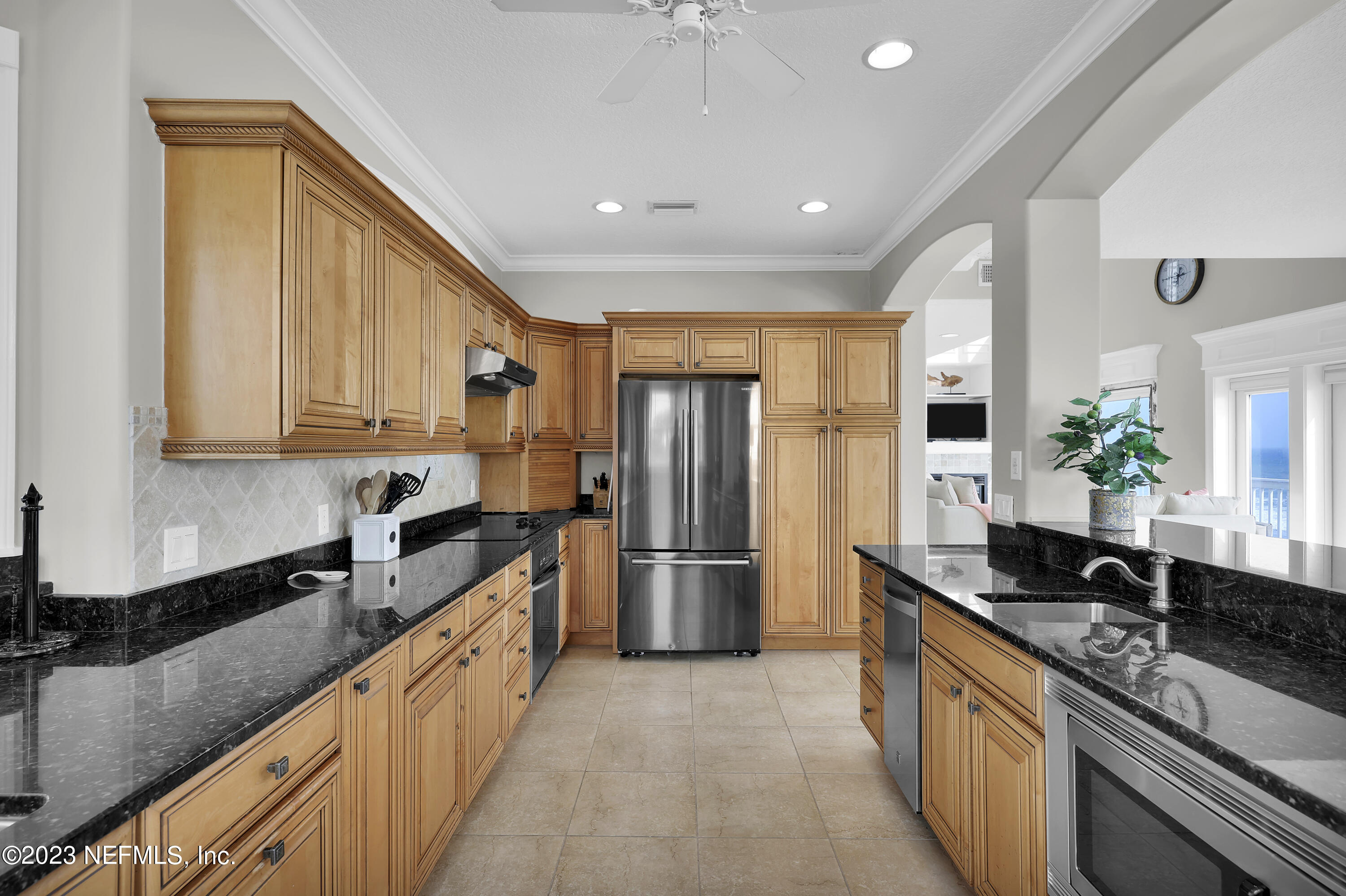 4582 Coastal Highway St. Augustine, FL 32084 - Photo 19 of 45 a large kitchen with stainless steel appliances granite countertop a sink a stove and a refrigerator