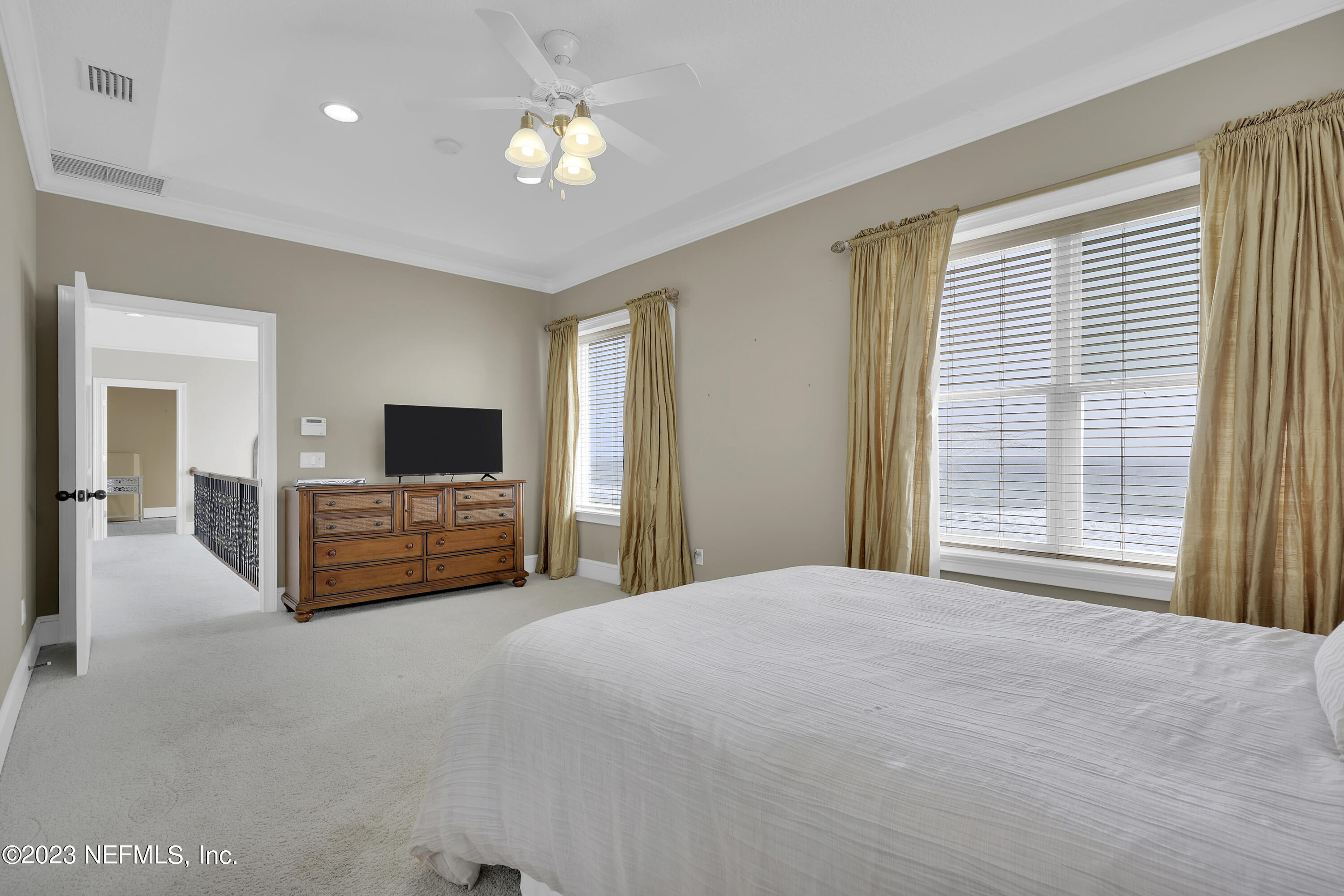 4582 Coastal Highway St. Augustine, FL 32084 - Photo 27 of 45 a large bedroom with a bed and a flat screen tv