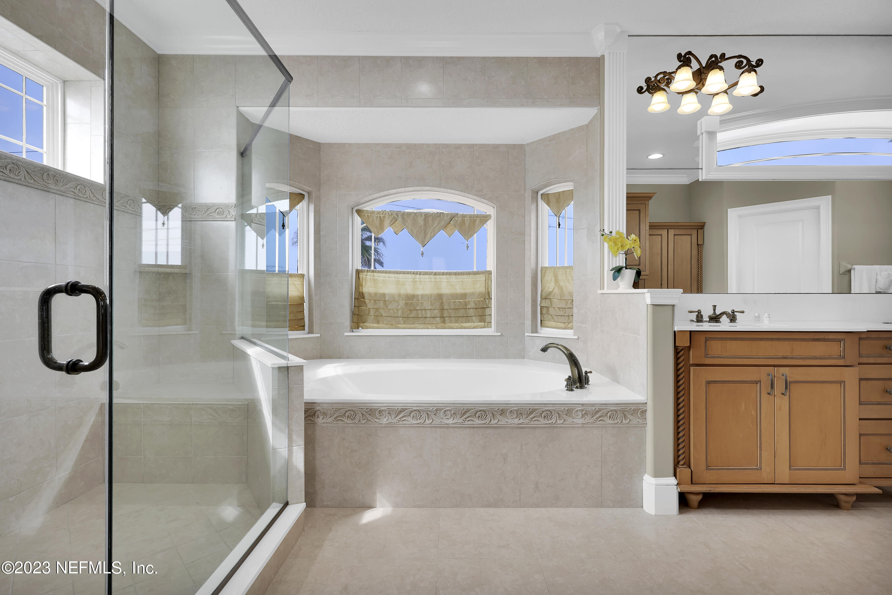 4582 Coastal Highway St. Augustine, FL 32084 - Photo 28 of 45 a bathroom with a tub sink and mirror