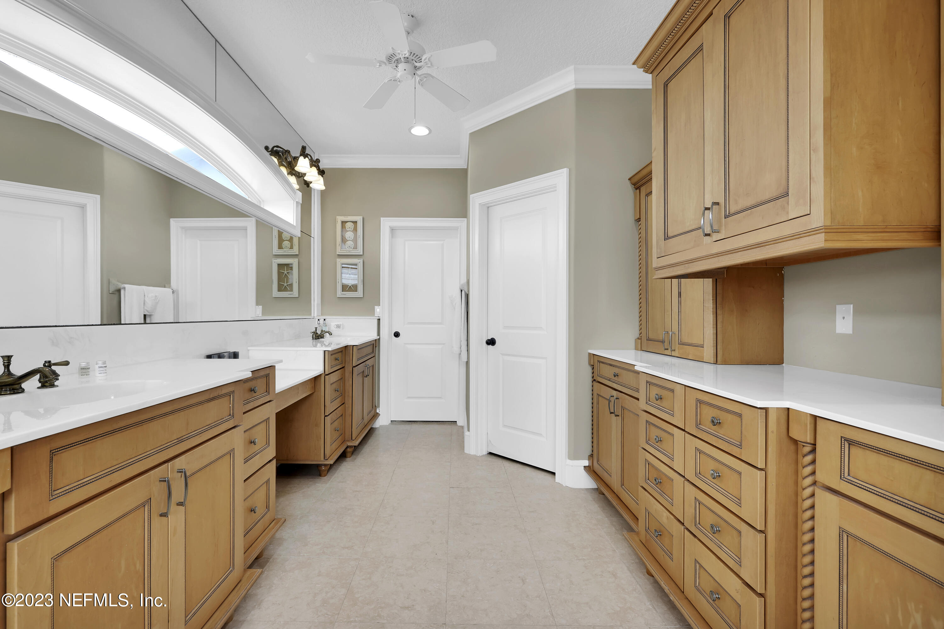 4582 Coastal Highway St. Augustine, FL 32084 - Photo 29 of 45 a large bathroom with a double vanity sink a mirror and a bathtub