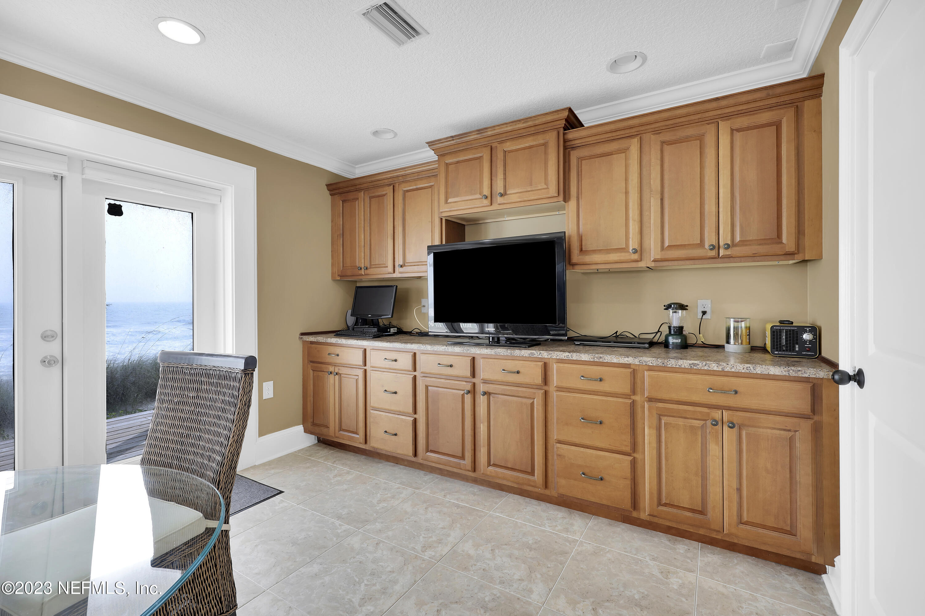 4582 Coastal Highway St. Augustine, FL 32084 - Photo 36 of 45 a kitchen with stainless steel appliances granite countertop a stove top oven a sink and a microwave