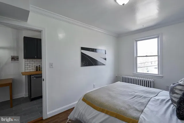 a bedroom with a bed and a television