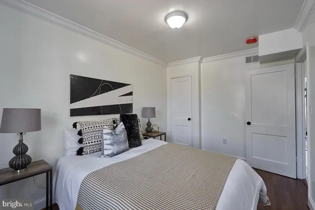 a bedroom with a bed and a lamp