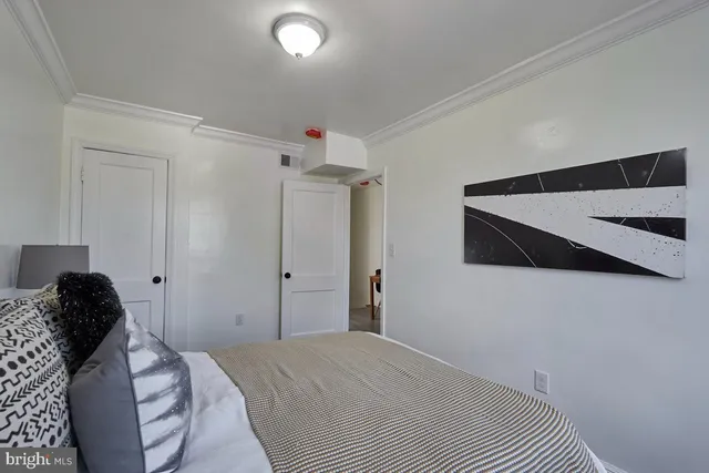 a bedroom with a bed and a painting on the wall