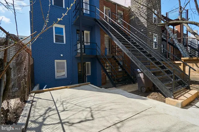 a view of a brick building with many windows
