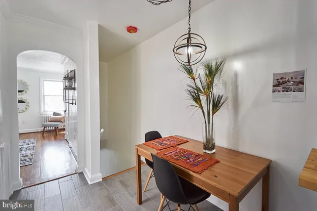 a view of a room with furniture and wooden floor