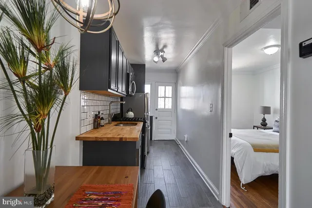 a en suite bathroom with a granite countertop sink a mirror and shower