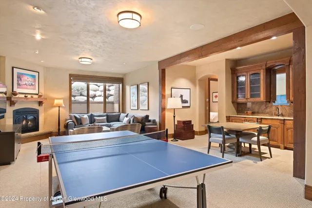 a room with furniture a large window and gym equipment