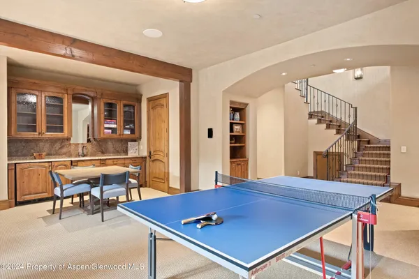 a room with furniture pool table and windows