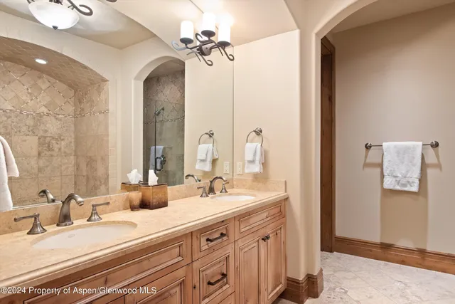 a bathroom with a double vanity sink mirror and