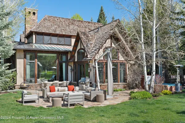 a view of a patio with couches table and chairs and garden