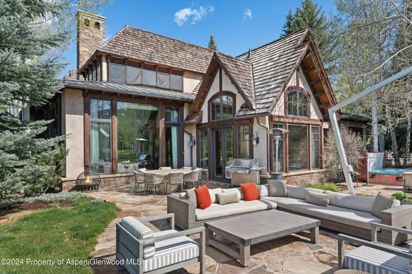 a backyard of a house with outdoor seating