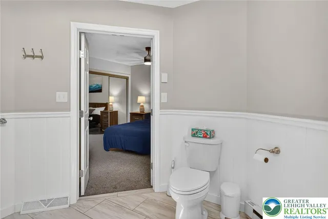 a bedroom with a large bed and a chandelier