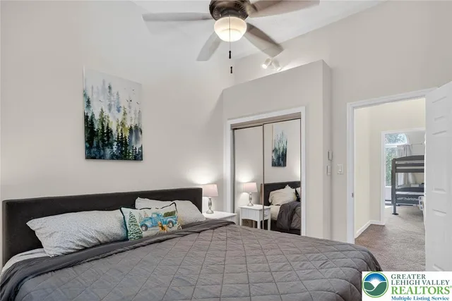 a bedroom with a bed and a large window