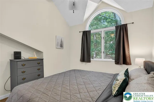 a bedroom with a bed and a mirror