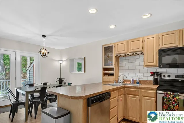 a kitchen with a table chairs sink and cabinets