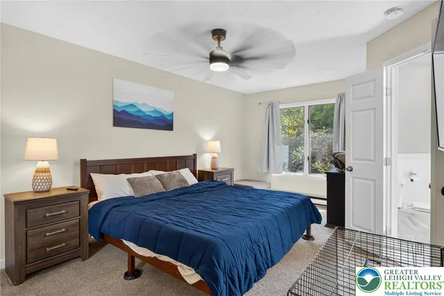 a bedroom with a bed and a large window