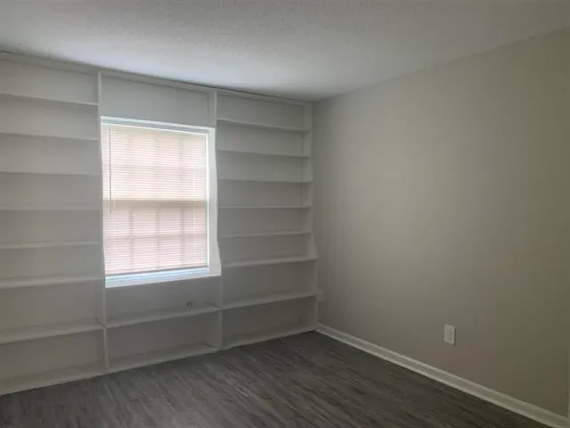 a view of a room with rack on the wall and a window